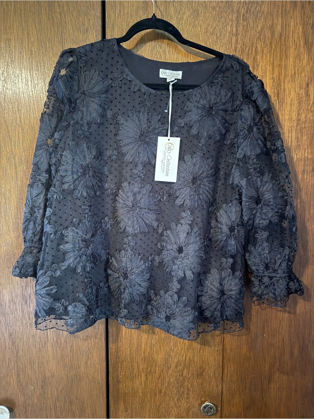 Black Cato Collection top with floral texture design and sheer sleeves